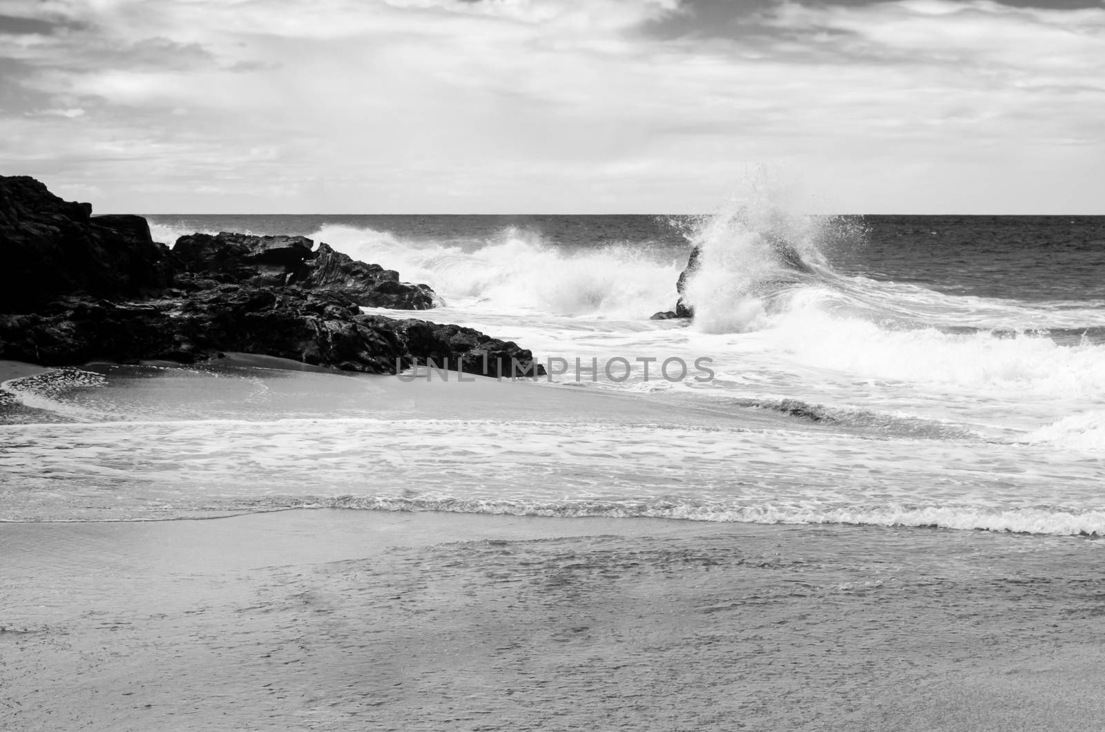 Waves beating against the rocks in Hawaii, US.  by mikelju