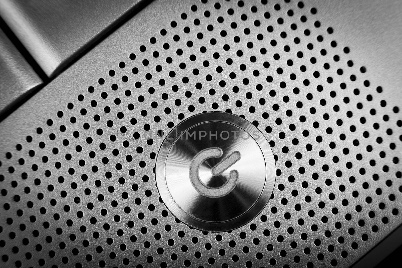 silver color  power button macro closeup  with holes grid arround