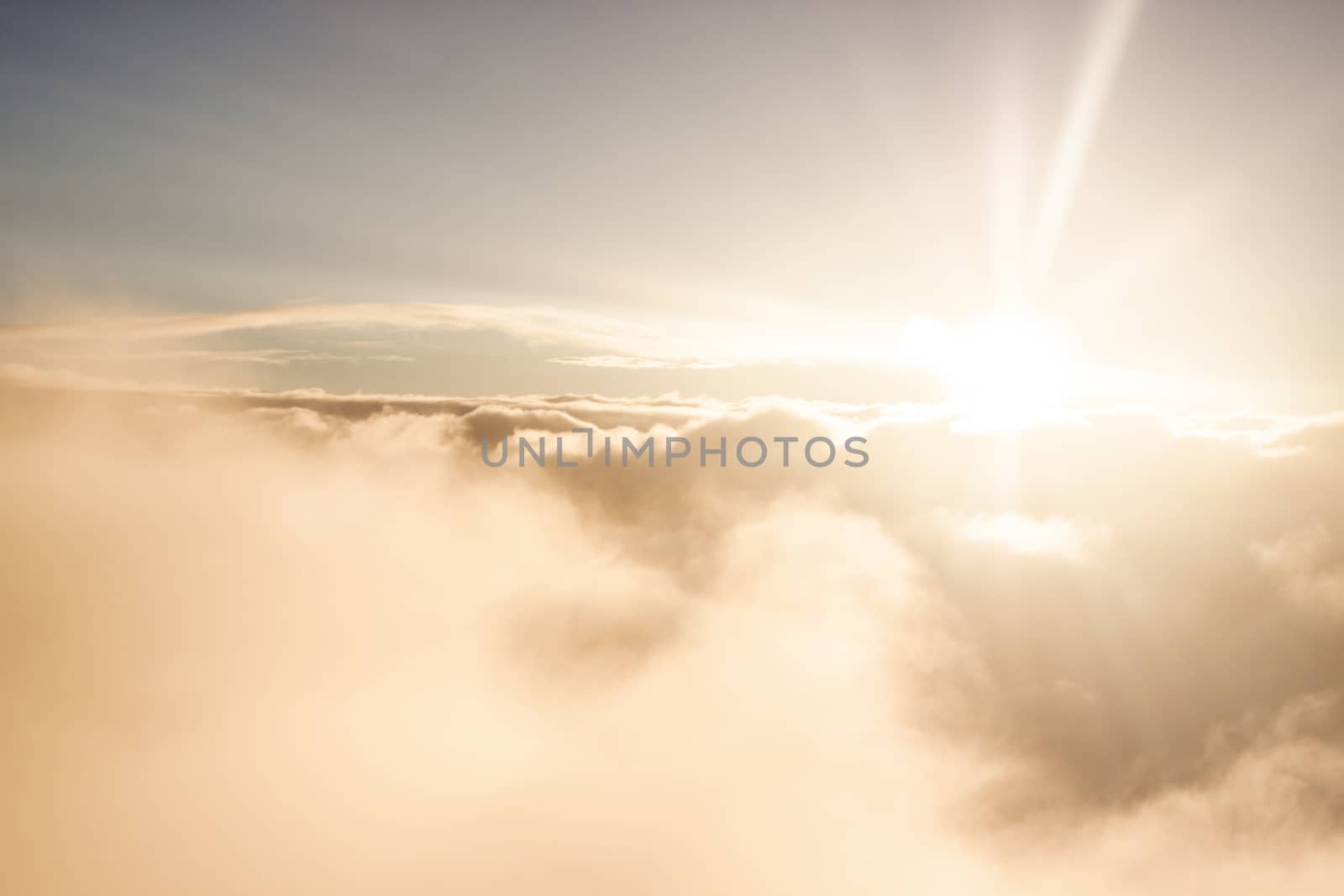 Sunrise above clouds during a flight bright light and colors