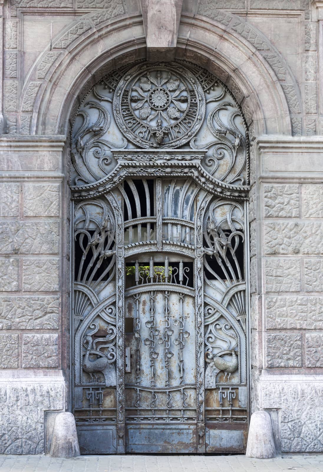 old blue iron entrance door with carving and iron textures