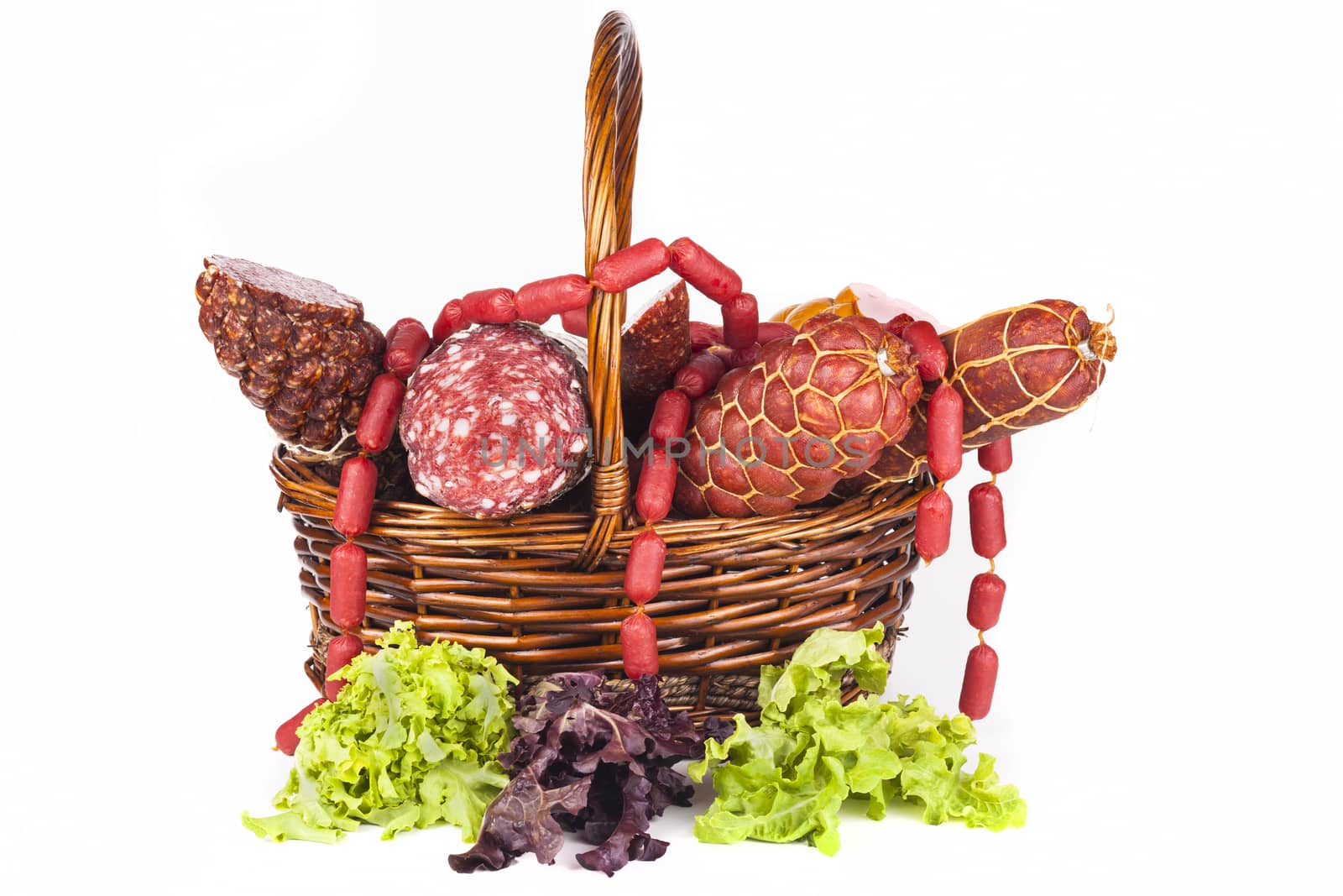 Basket full with salami and green salad aside