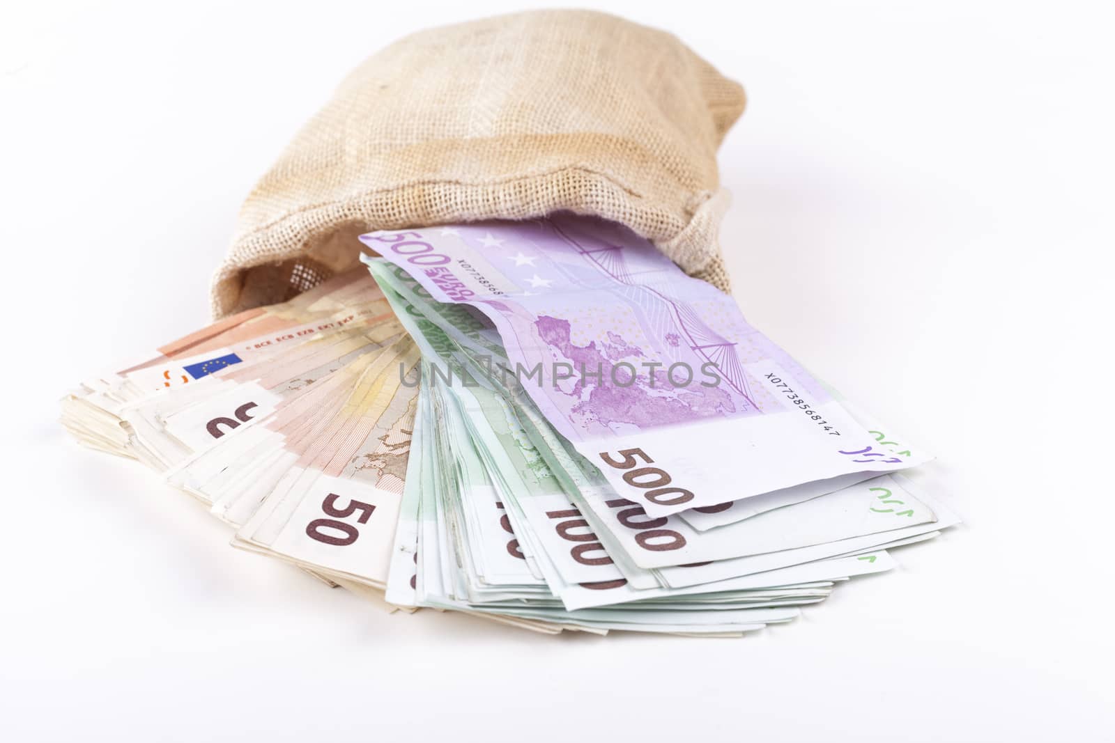 A bag full with euro banknotes pouring out isolated on white background