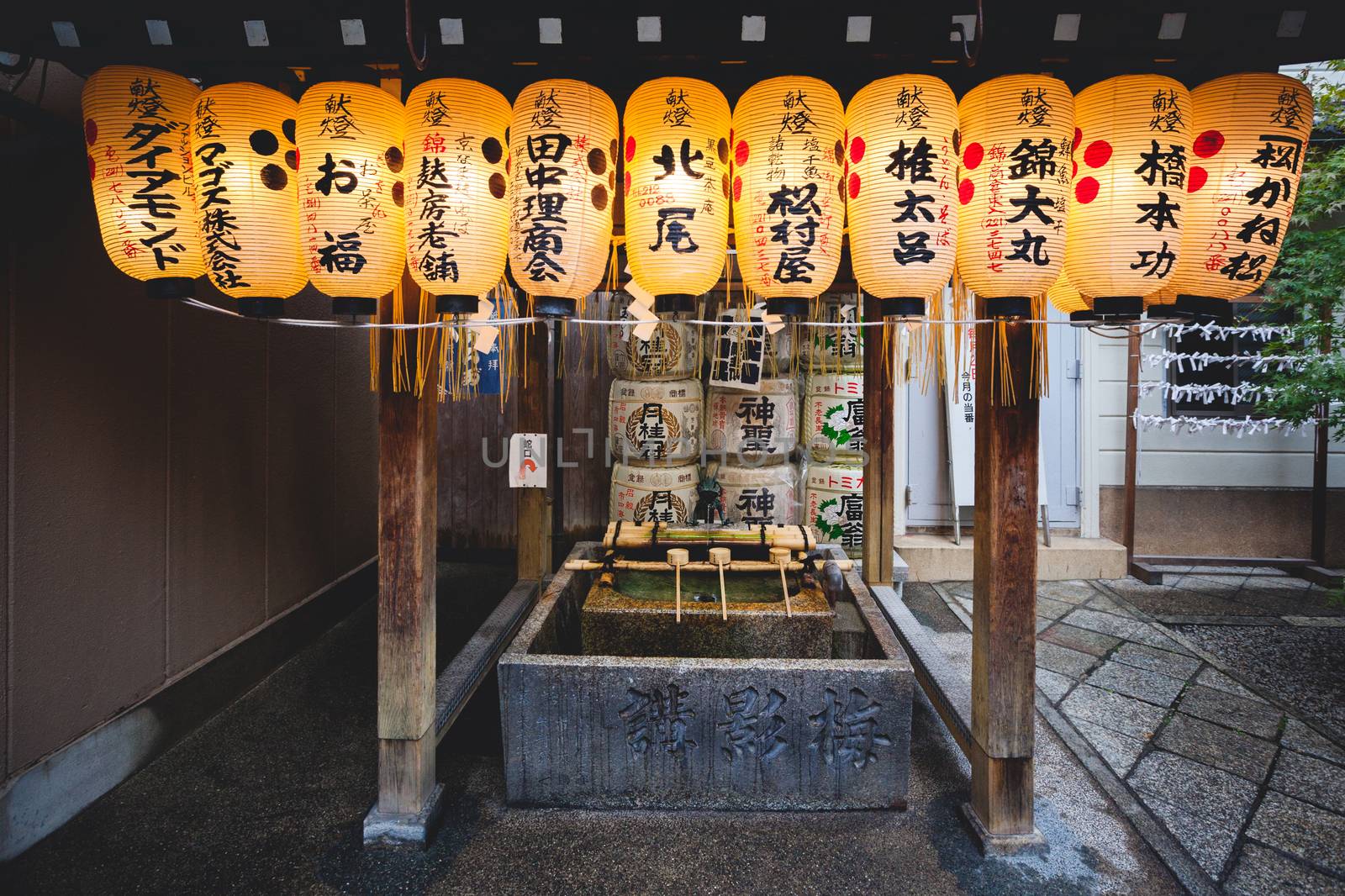 Japanese paper lanterns hanging on water ablution pavilion for a ceremonial purification at Nishiki Tenmangu Shrine in Kyoto, Japan
