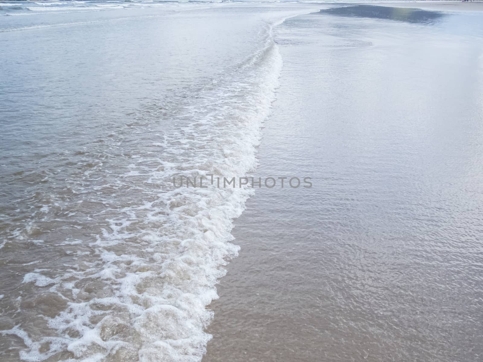 Ripple texture, with foam at the seaside, in shallow sea.