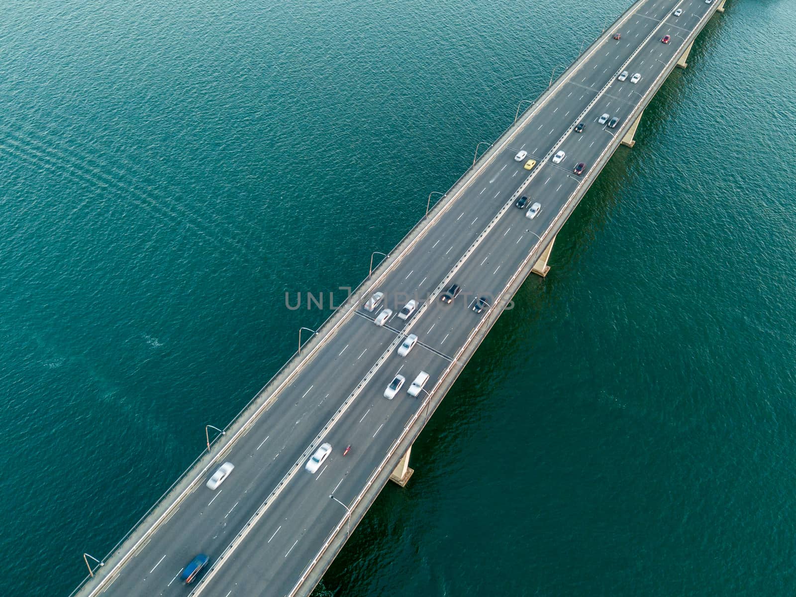 Cars and other vehicles travelling across the Captain Cook Bridge. The bridge crosses near the river mouth as it empties into Botany Bay; and links the St George and Sutherland areas of Sydney.