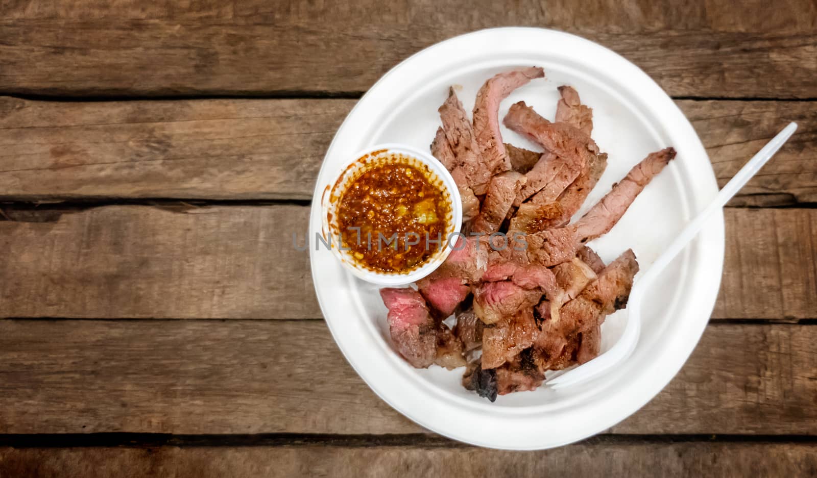 Top view of grilled beef with spicy sauce , Thai style food