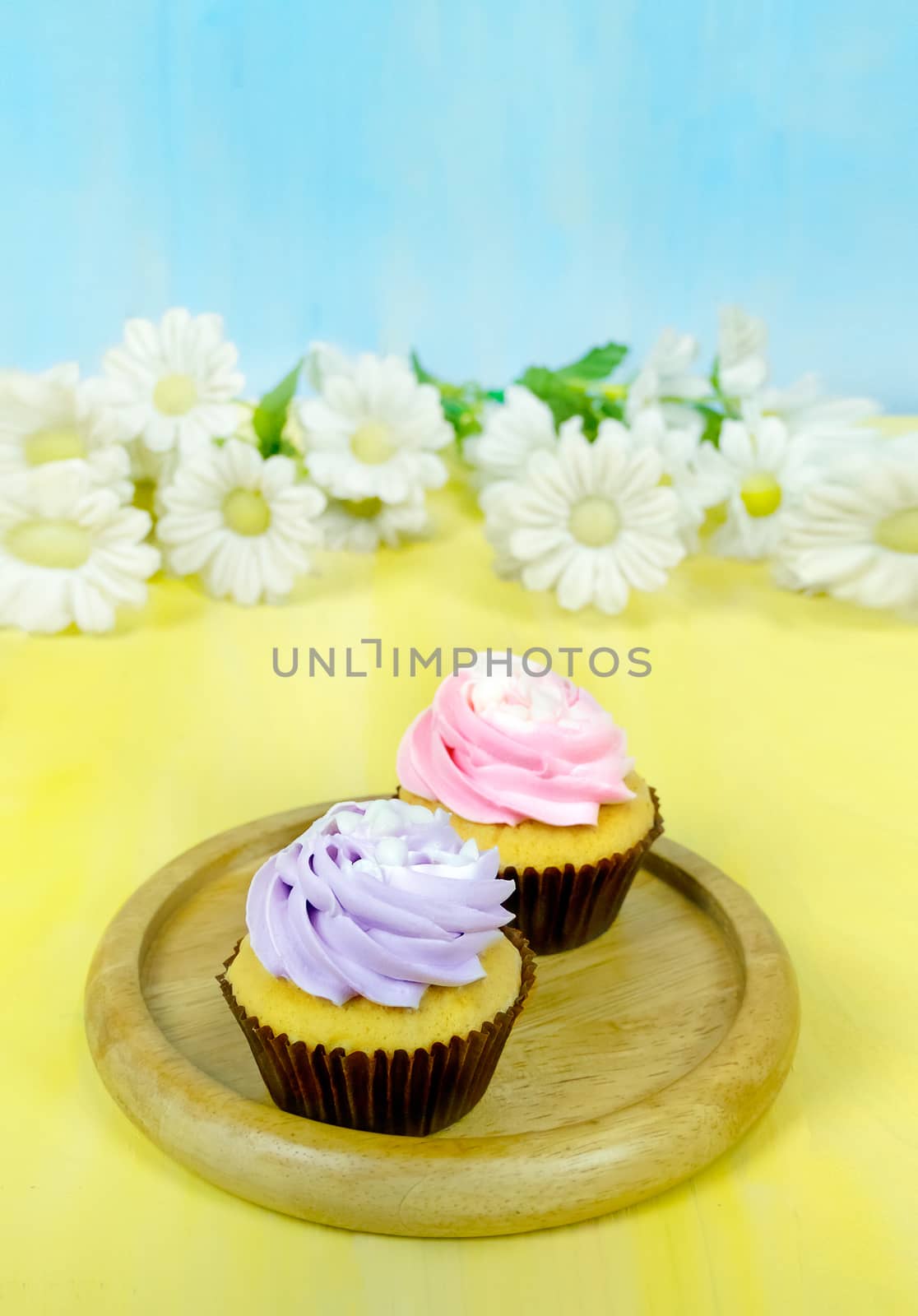 Tasty cupcakes with  whipping cream  by rakratchada