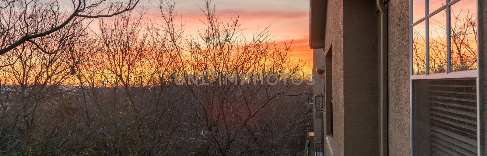 Panorama view typical park side apartment complex during winter sunrise with dramatic cloud reflection on windows. Aerial view of apartment building in Texas, America