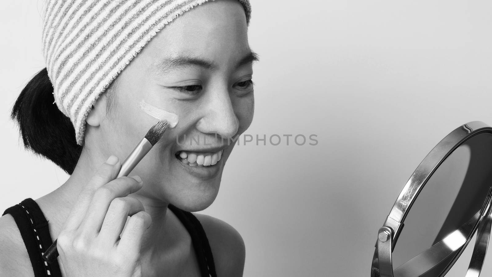 Asian woman beautiful face make up by foundation liquid  by gnepphoto