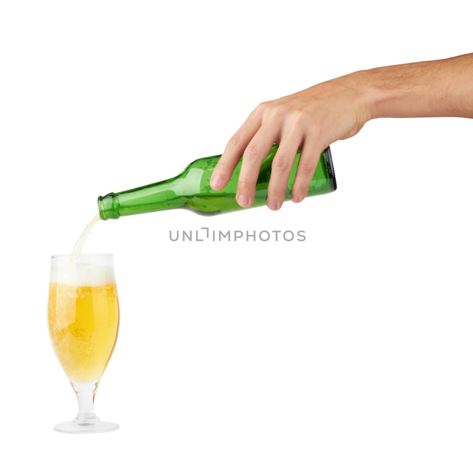Beer pouring from bottle into glass on white background 