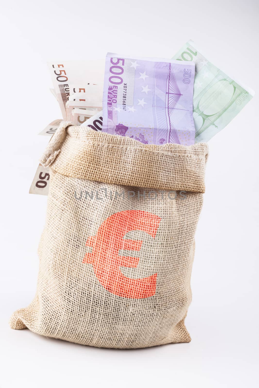 A bag full with euro banknotes with euro sign on the bag isolated on white background