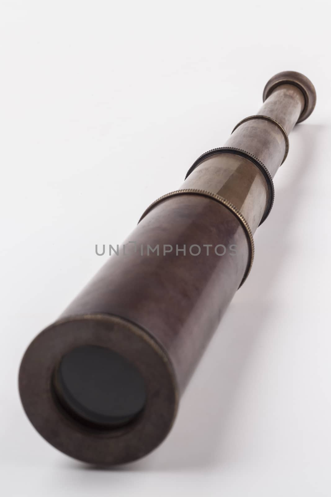 Old telescope close-up isolated on white background