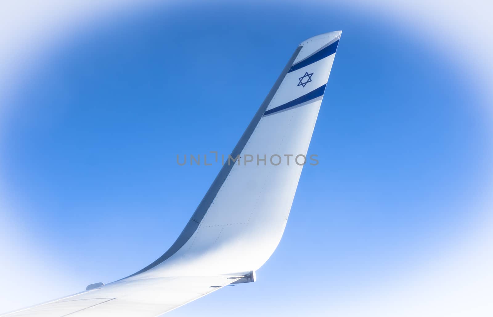 Israeli flag on plane wing on blue sky background