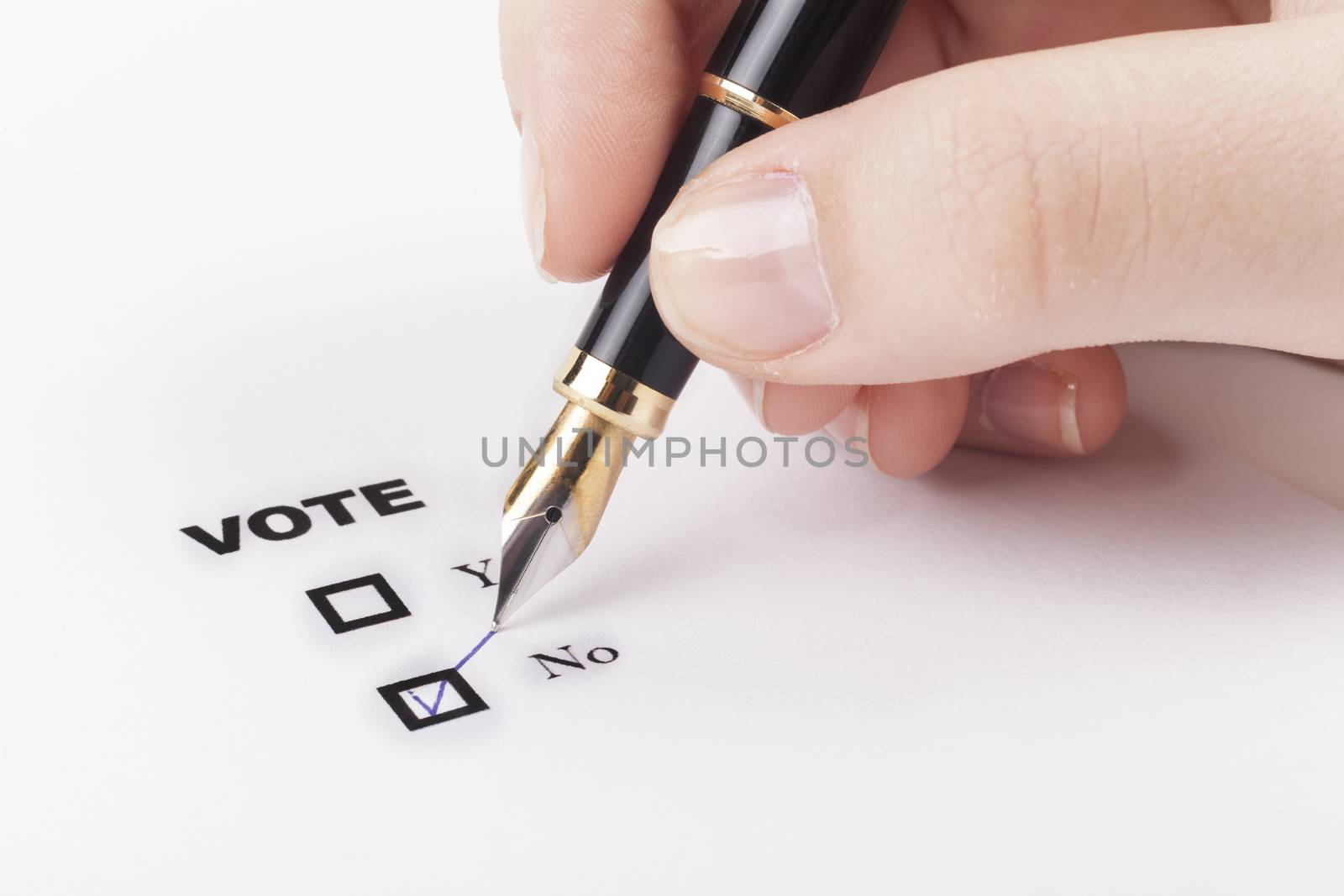 Woman hand voting no in check-box with blue fountain pen