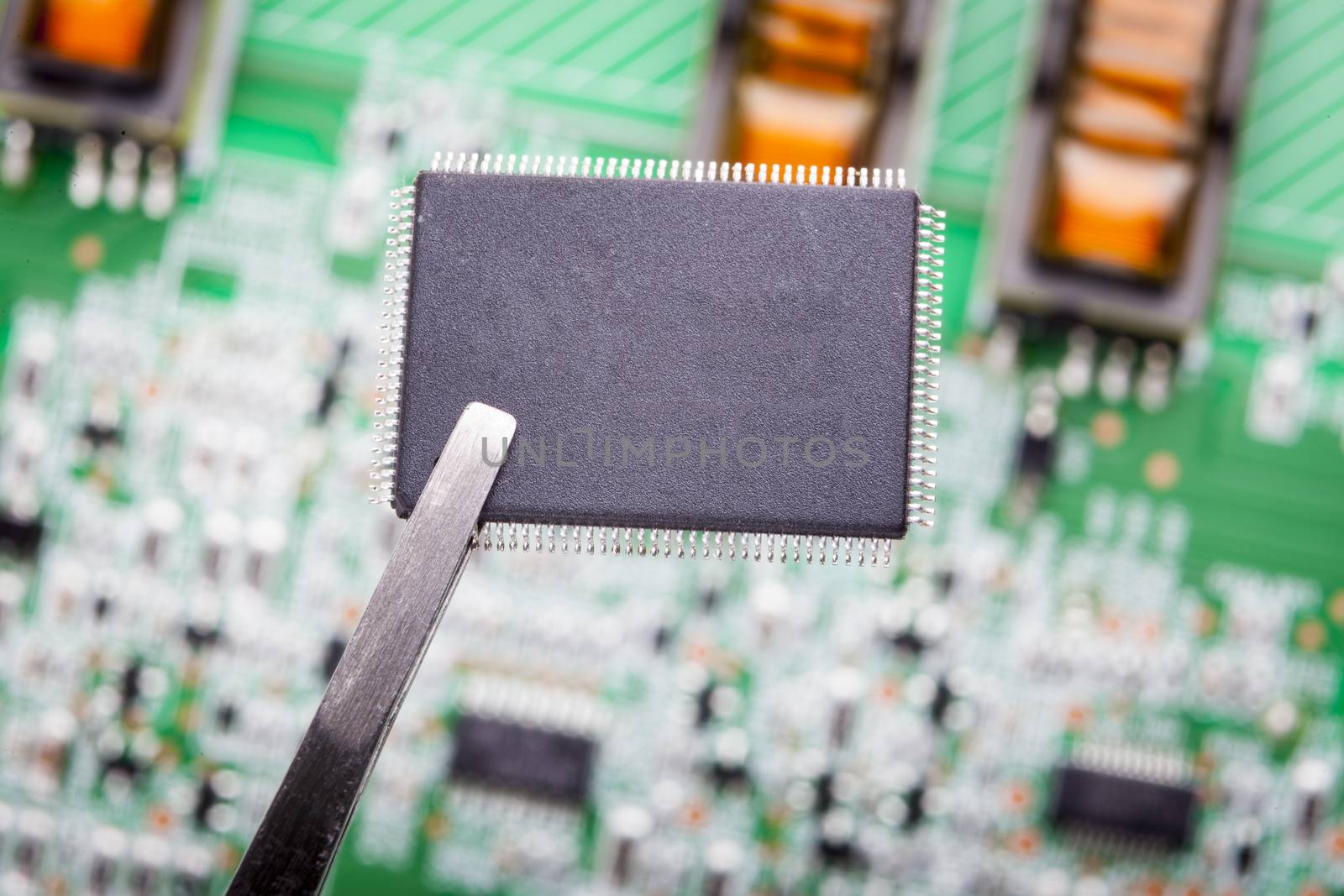 Micro Chip  macro close-ip with circuit board in the background
