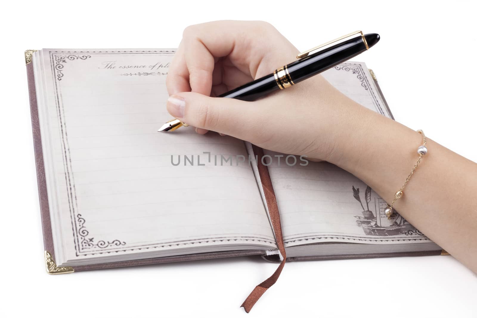 Female hand writing empty page in diary with fountain pen
