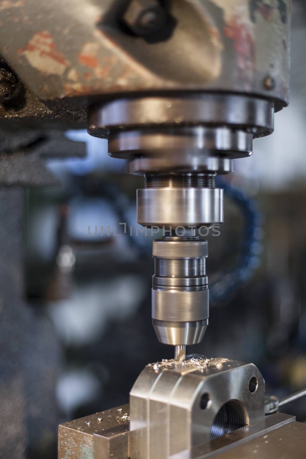 Old industrial drill working in metal workshop