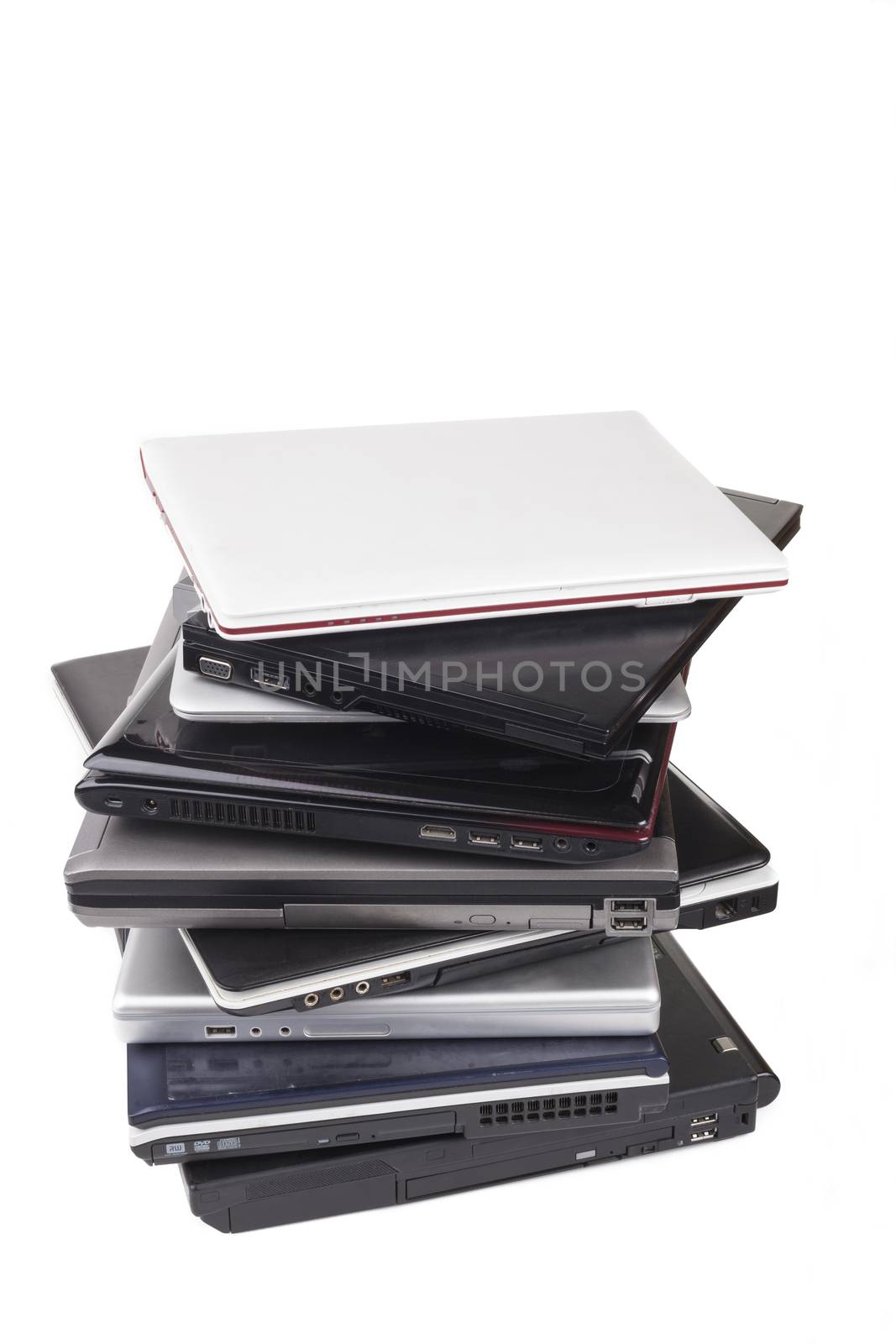 Pile of old laptops isolated on white background