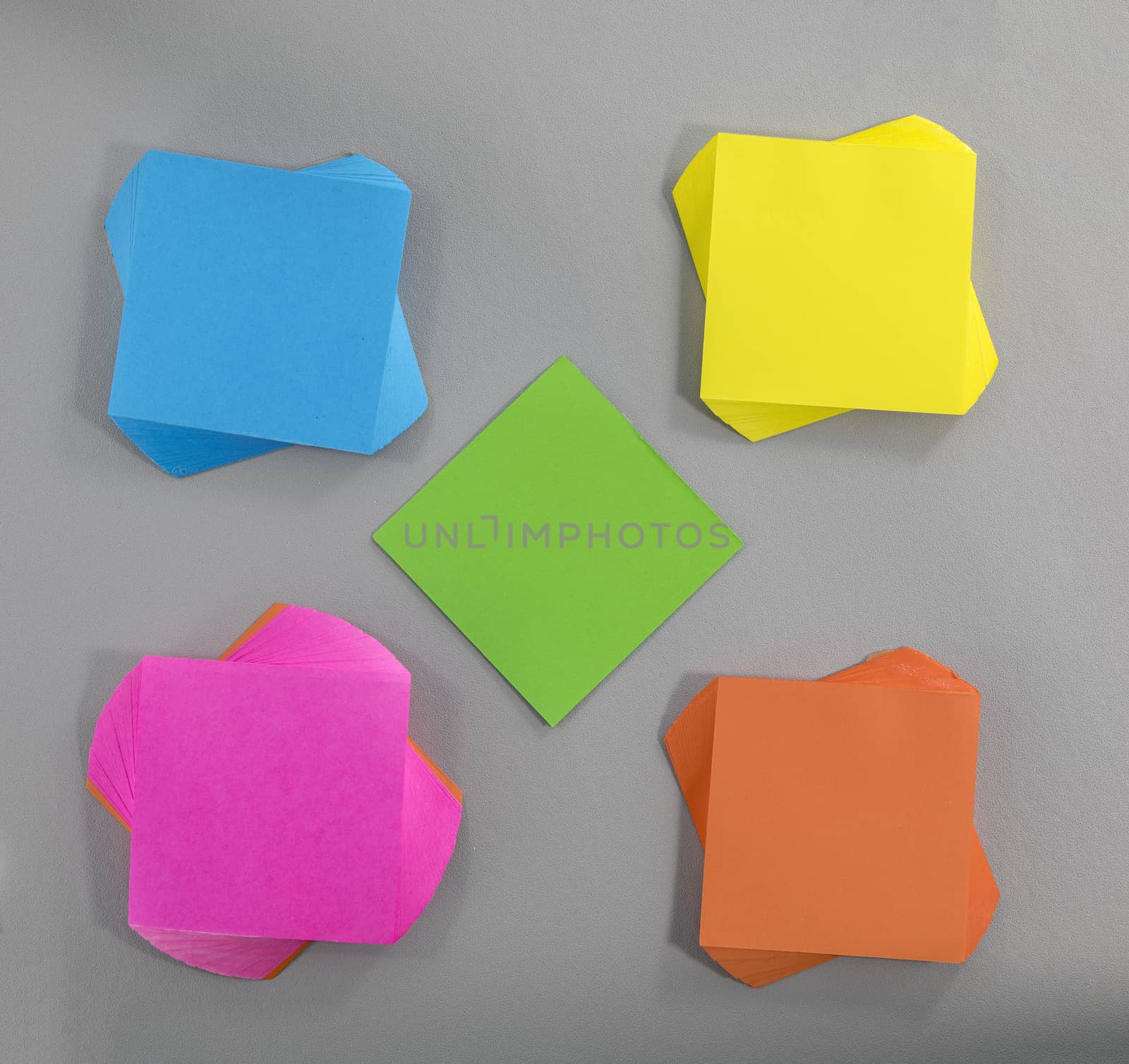 colorful sticky notes in different sizes shapes and colors on grey  background