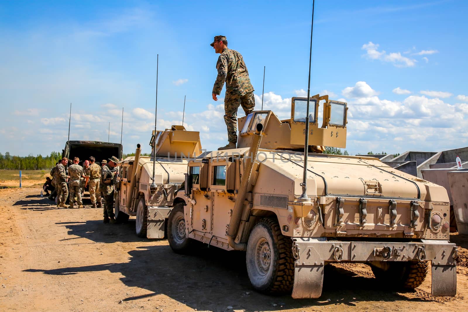 NATO Hummer military vehicles. Soldier on armored Hummer. International Military Training "Saber Strike 2017", Adazi, Latvia, from 3 to 15 June 2017. US Army Europe-led annual International military exercise Saber Strike Field Training Exercise in Latvia.