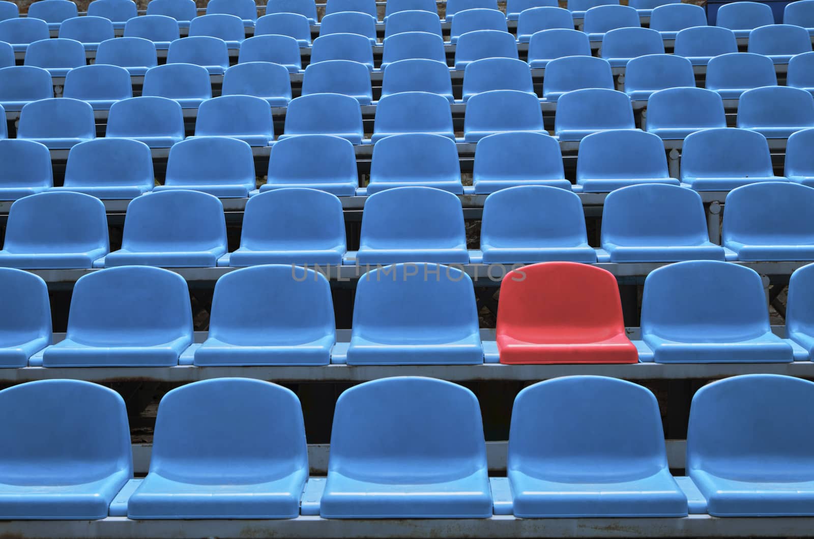 Background of empty seats in a stadium with one special