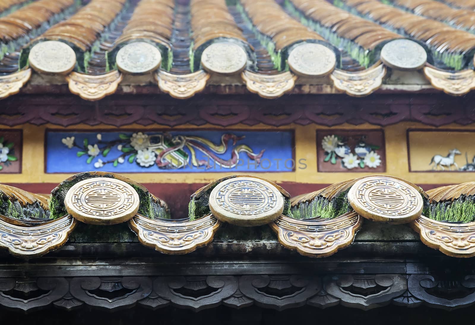 Close up of roof of Buddhist temple, Vietnam, with longevity symbols