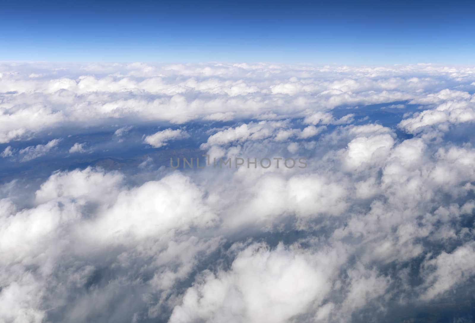 Wing of an airplane and the land below