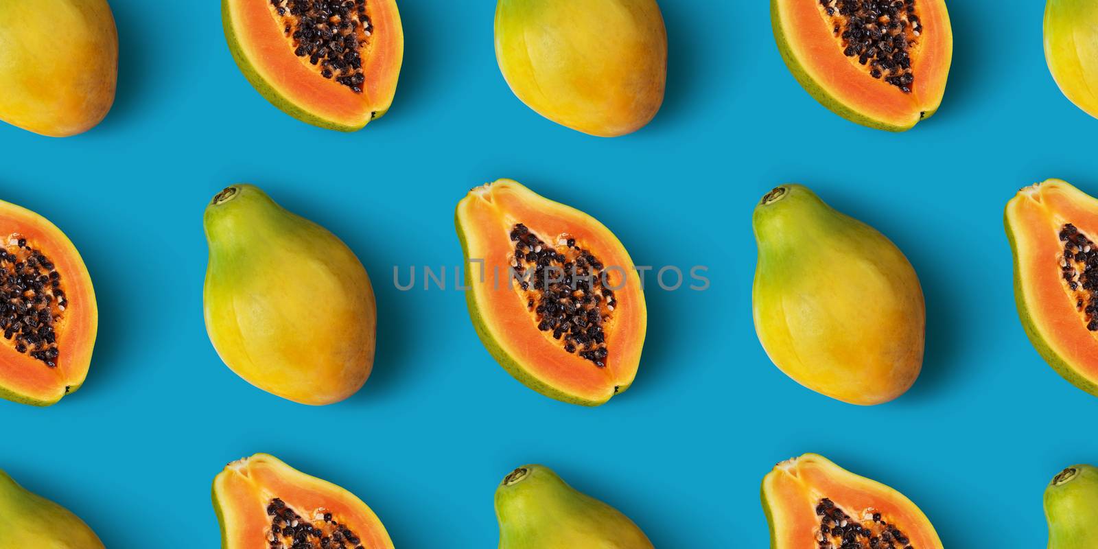 Papaya fruit seamless pattern on blue color background, flat lay, top view