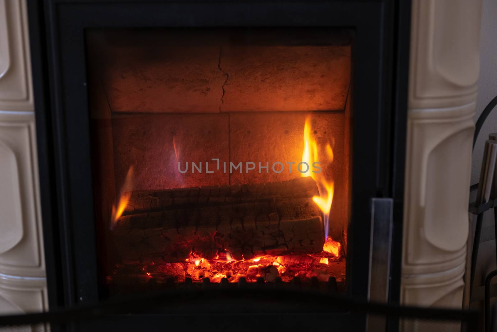 Fire in stove, close up, firewood burning, detail interior scene, winter concept