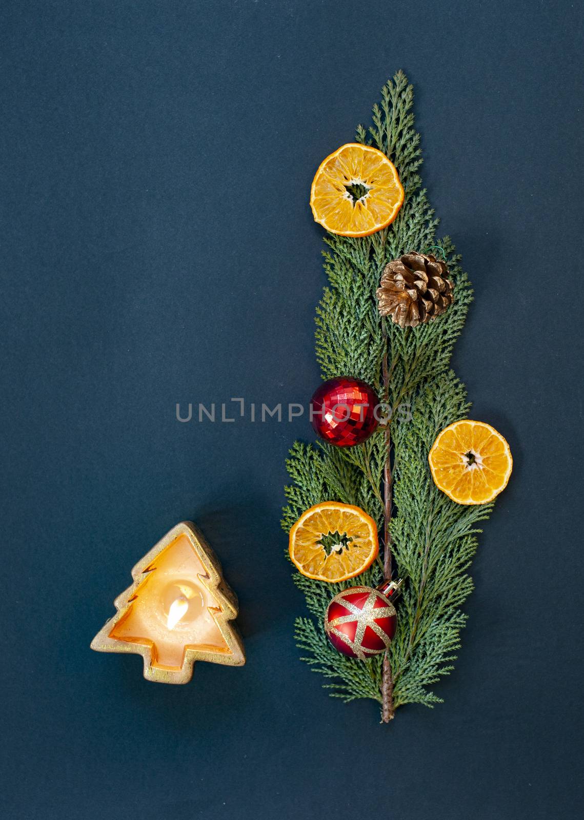 flat lay of christmas arrangement with candles  oranges  decorations on fir branch