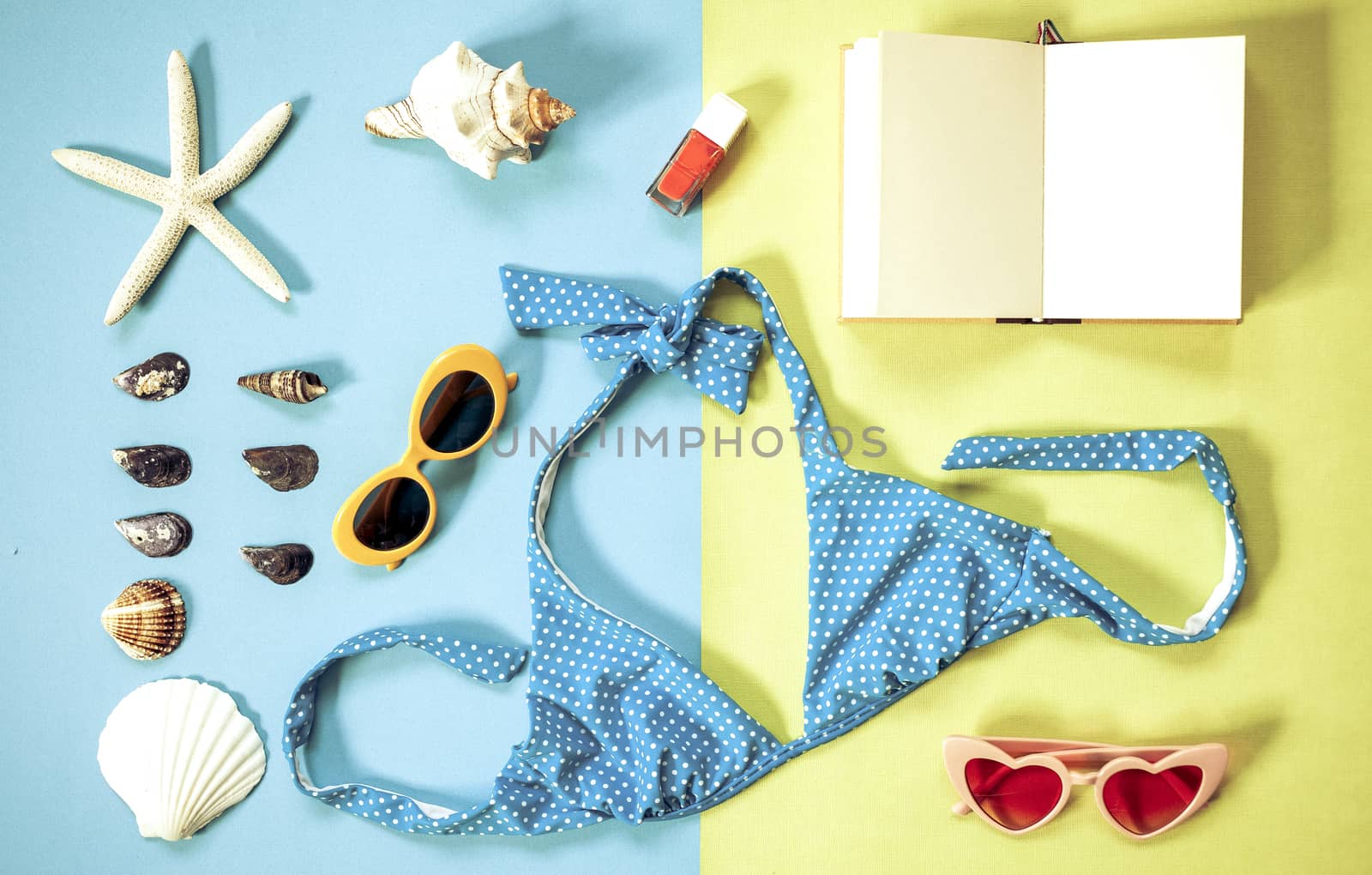 flat lay of beach holiday items: swimming suit,  sunglasses,  sm by melis