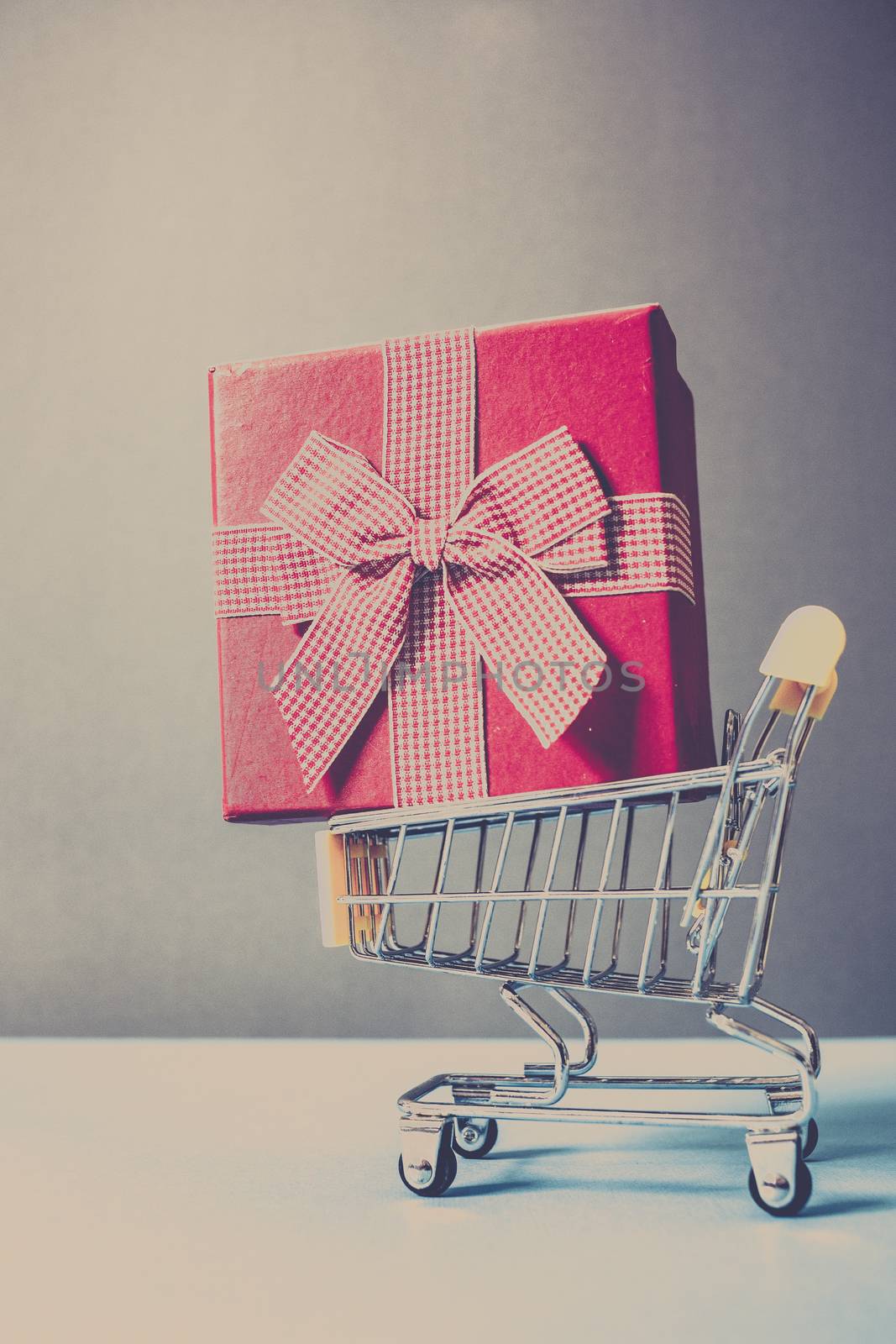 huge red gift box in shopping cart - online shopping