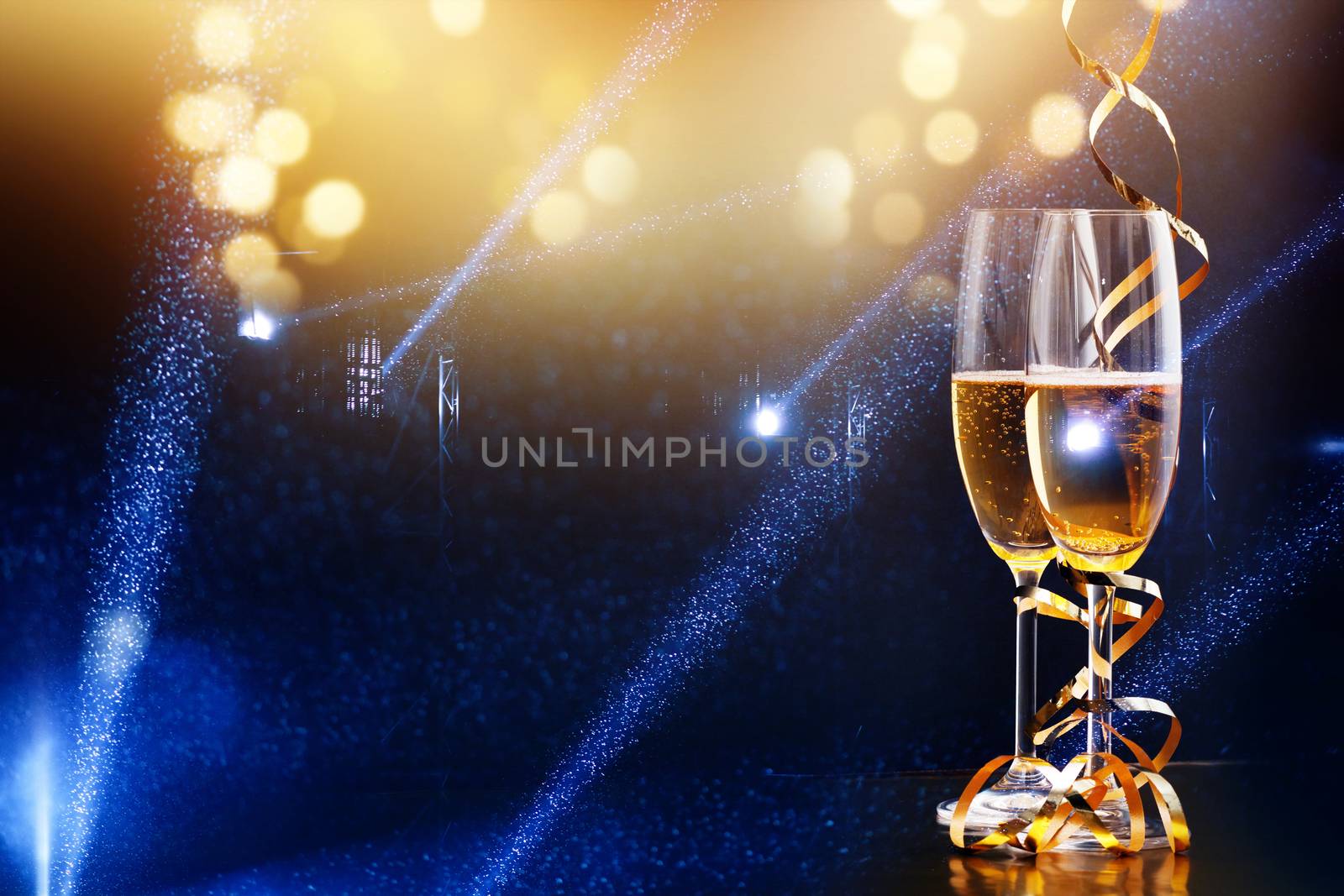 two glasses of champagne in the spotlight - new year celebration by melis