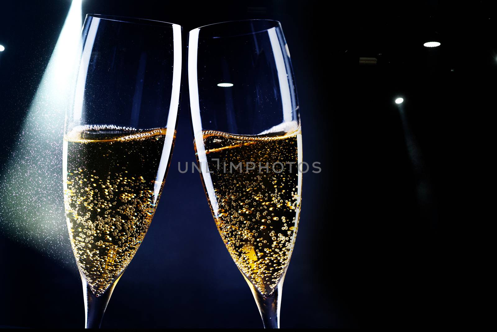 two glasses of champagne in the spotlight - new year celebration