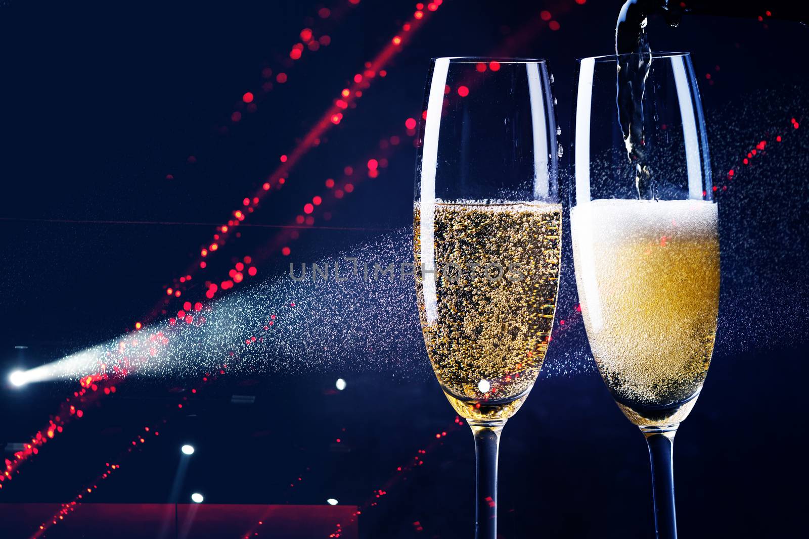 two glasses of champagne in the spotlight - new year celebration