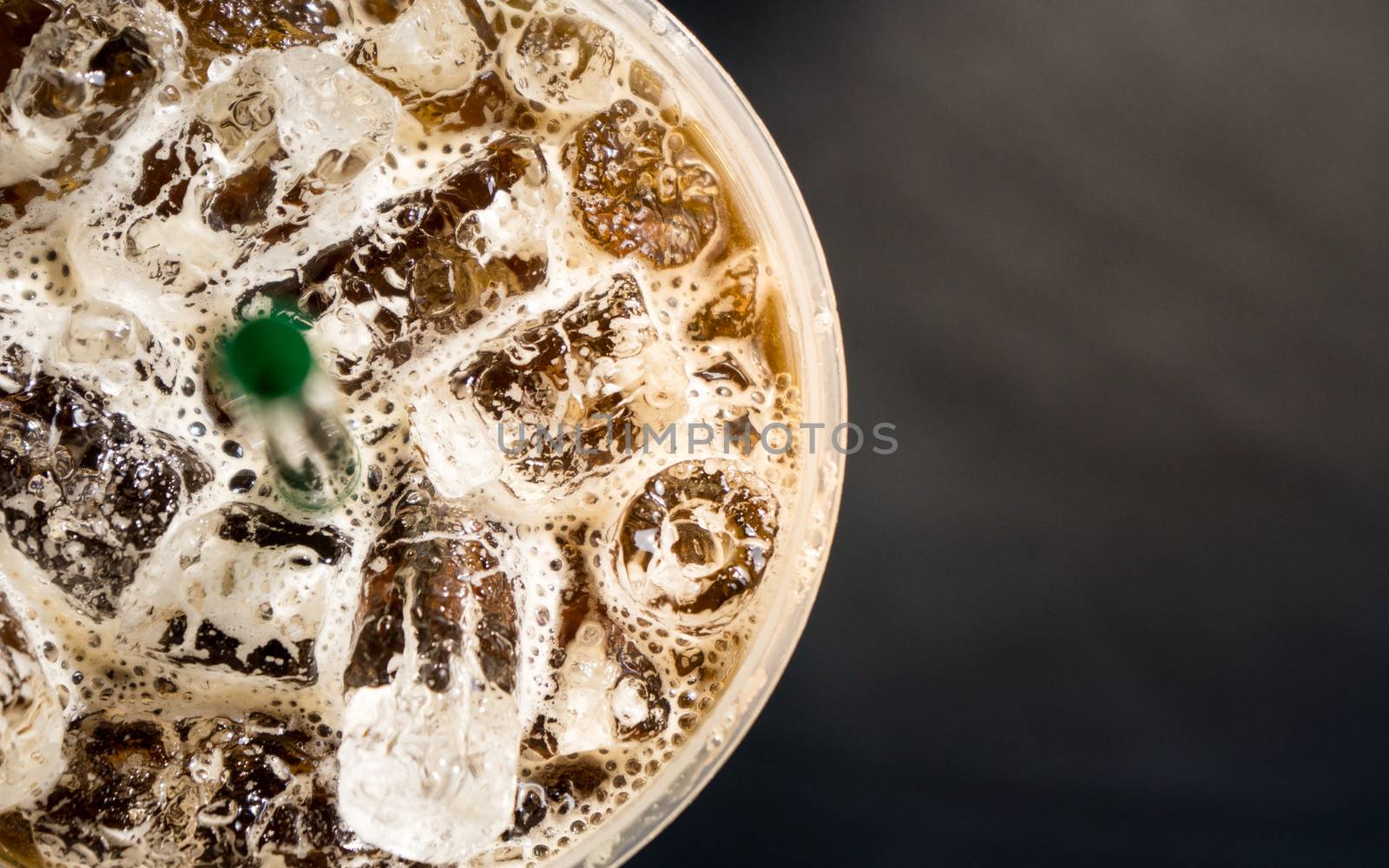 top view of Ice coffee in a plasstic glass with straw