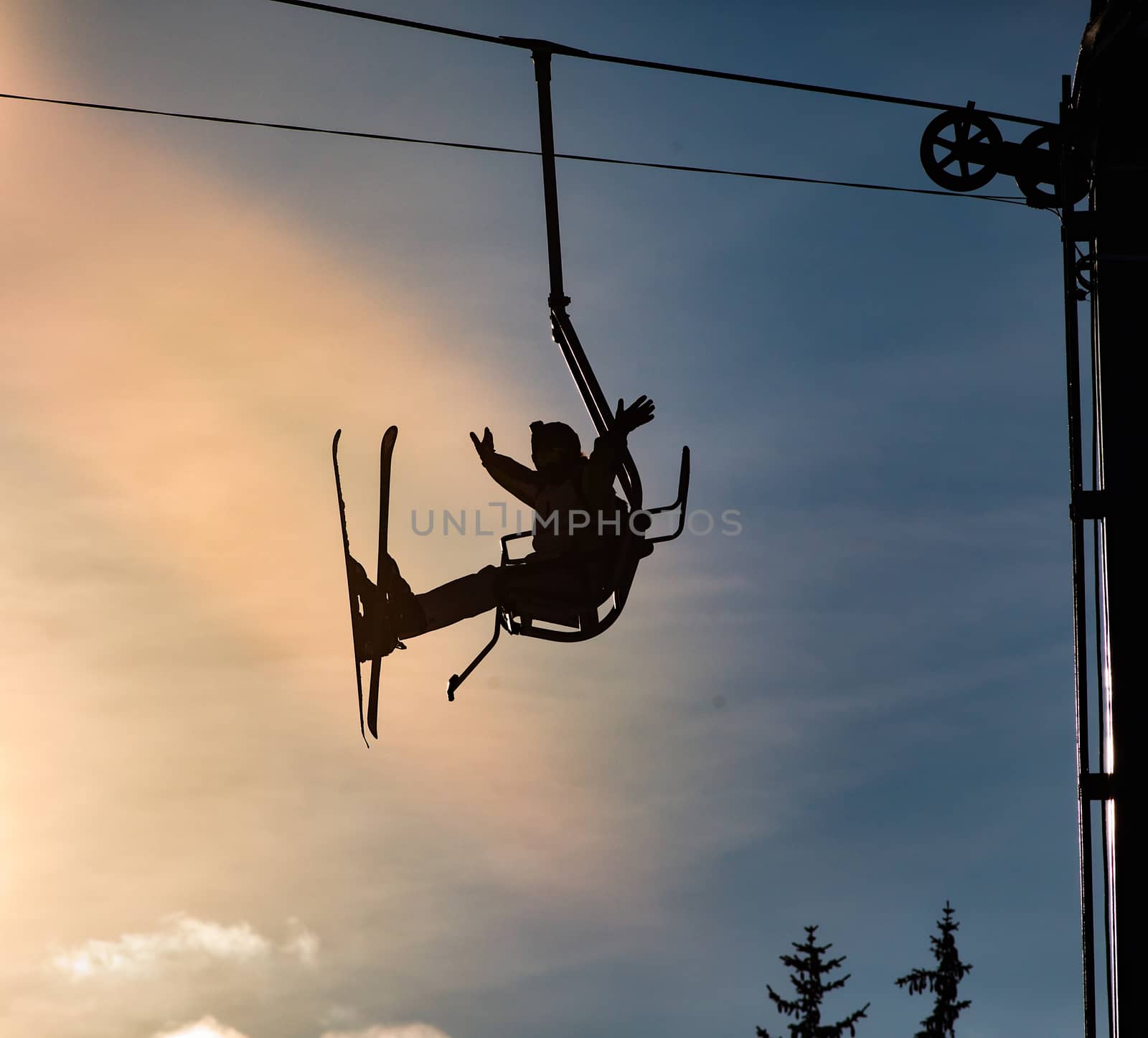 silhouette of a man on a ski lift
