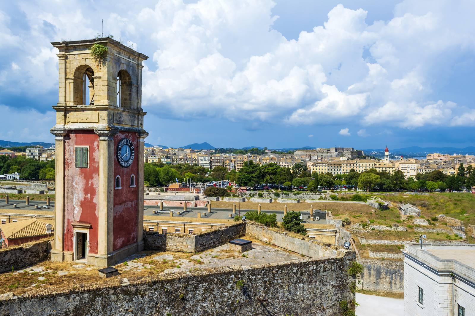 Abandoned clock tower in old fortress in Corfu with panoramic view of Corfu town at Greece.