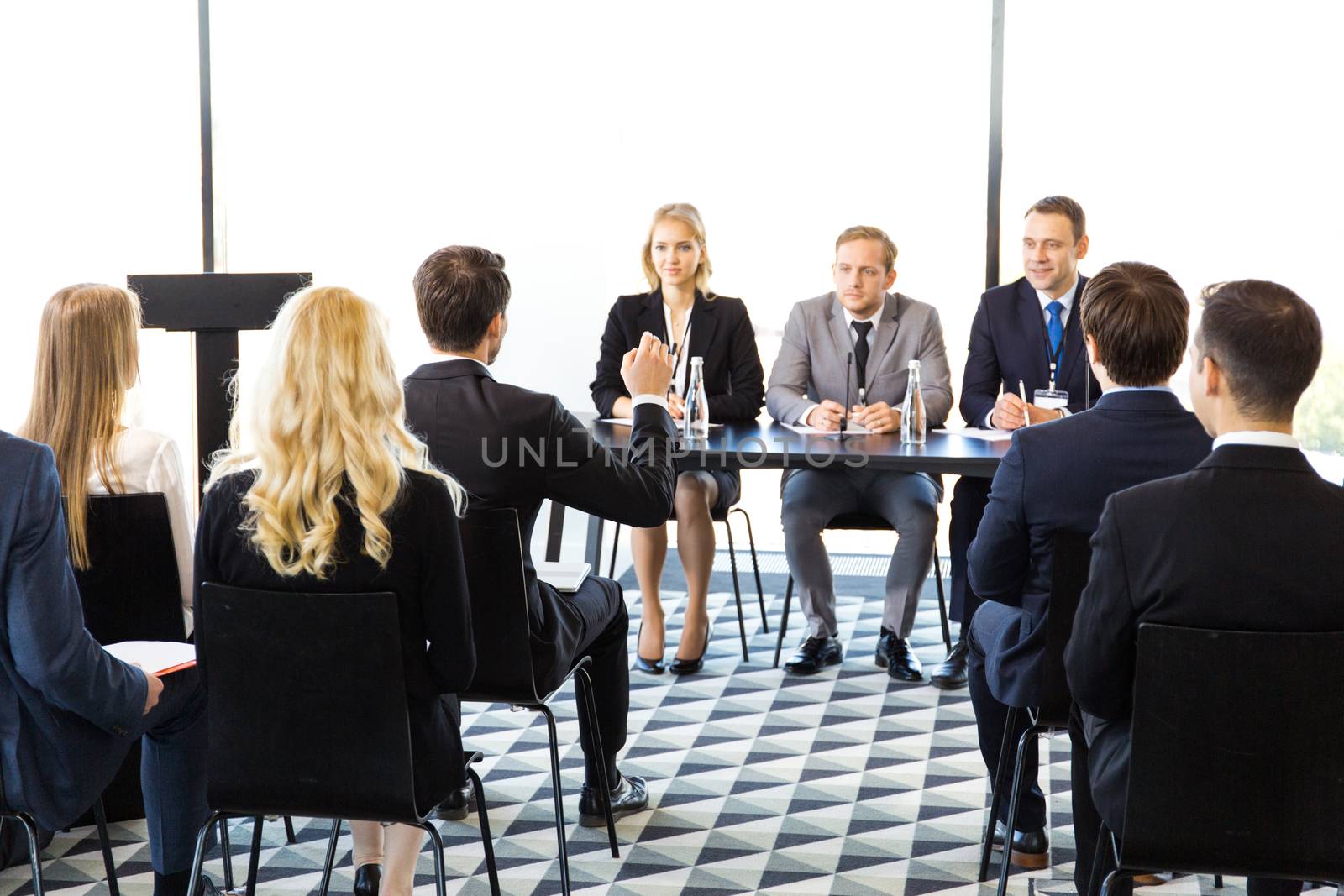 Business man from audience asking question at seminar