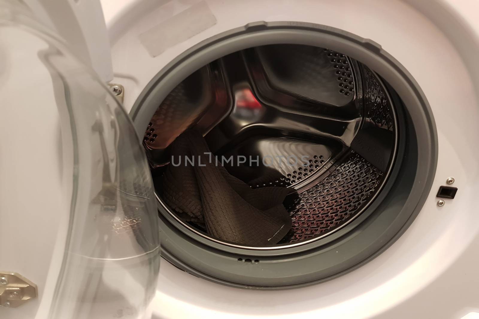 Opened door of a washing machine to prepare the wash.