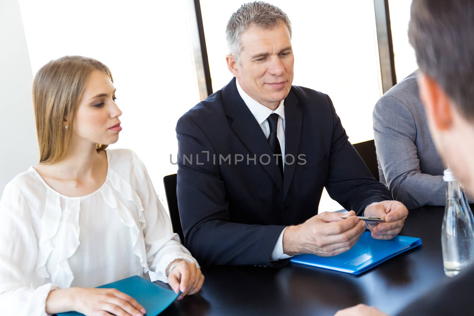 Business people discussing documents at workplace in office
