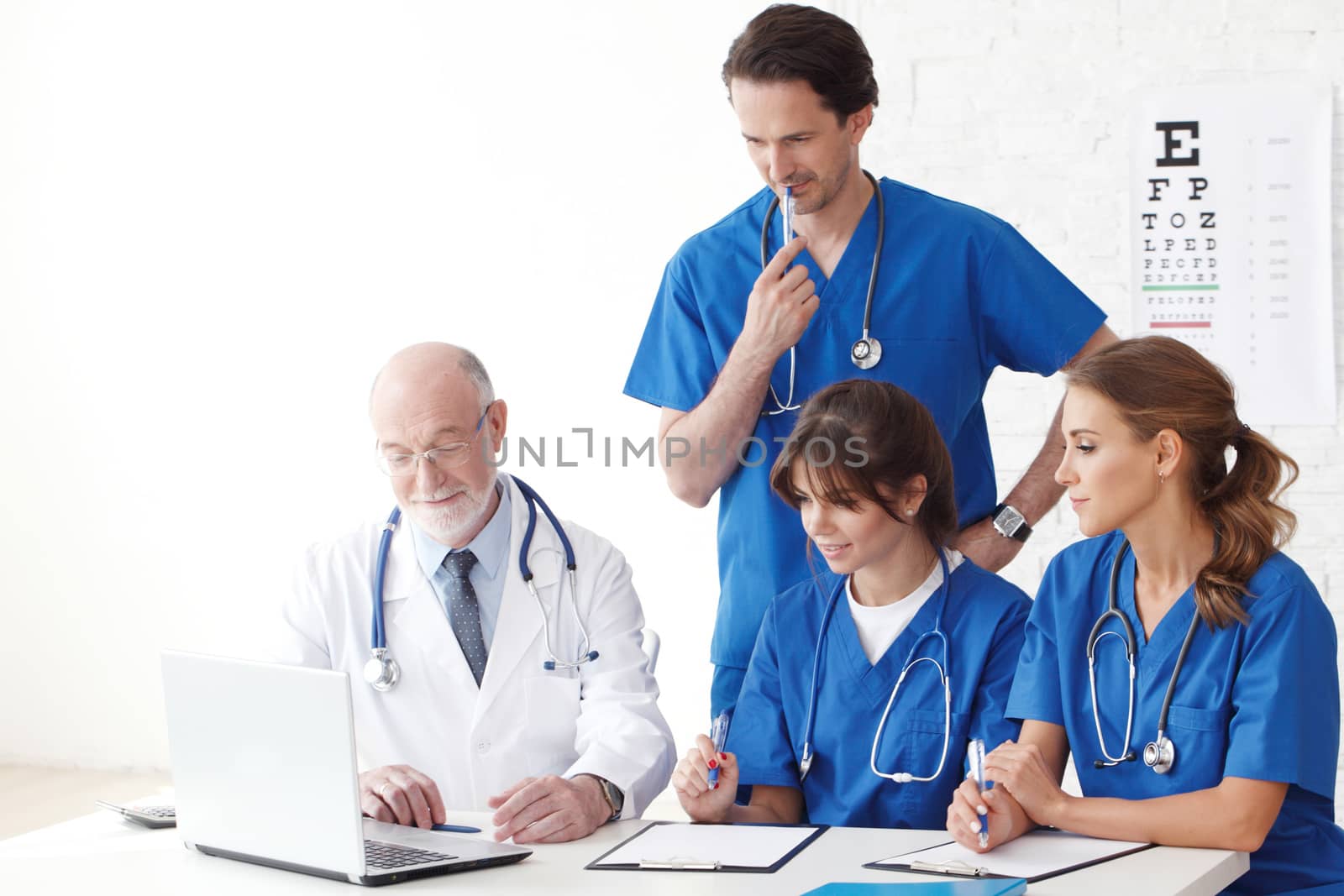 Medical doctors team using computer isolated on white
