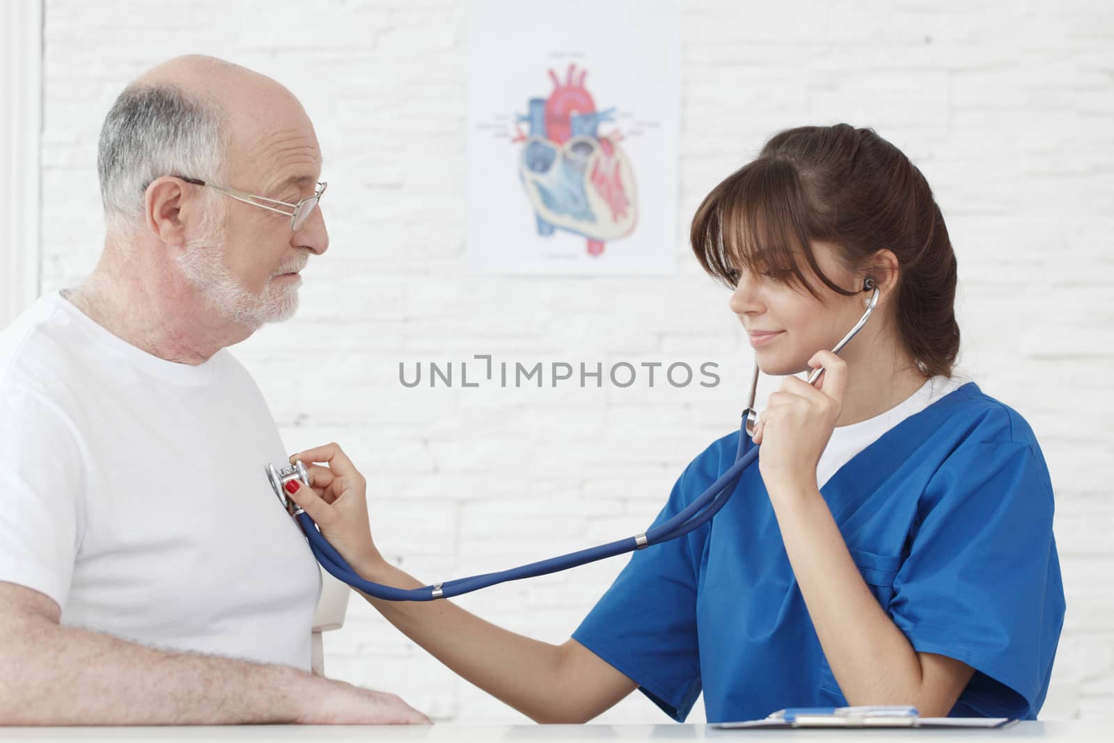 Doctor examining heartbeat of senior male patient