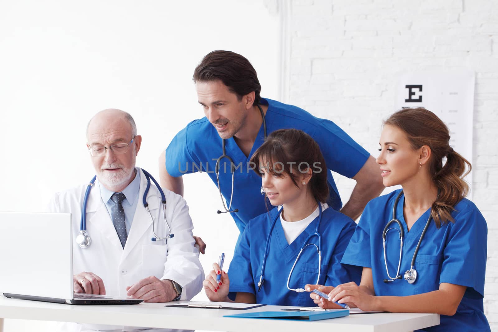 Medical doctors team using computer isolated on white