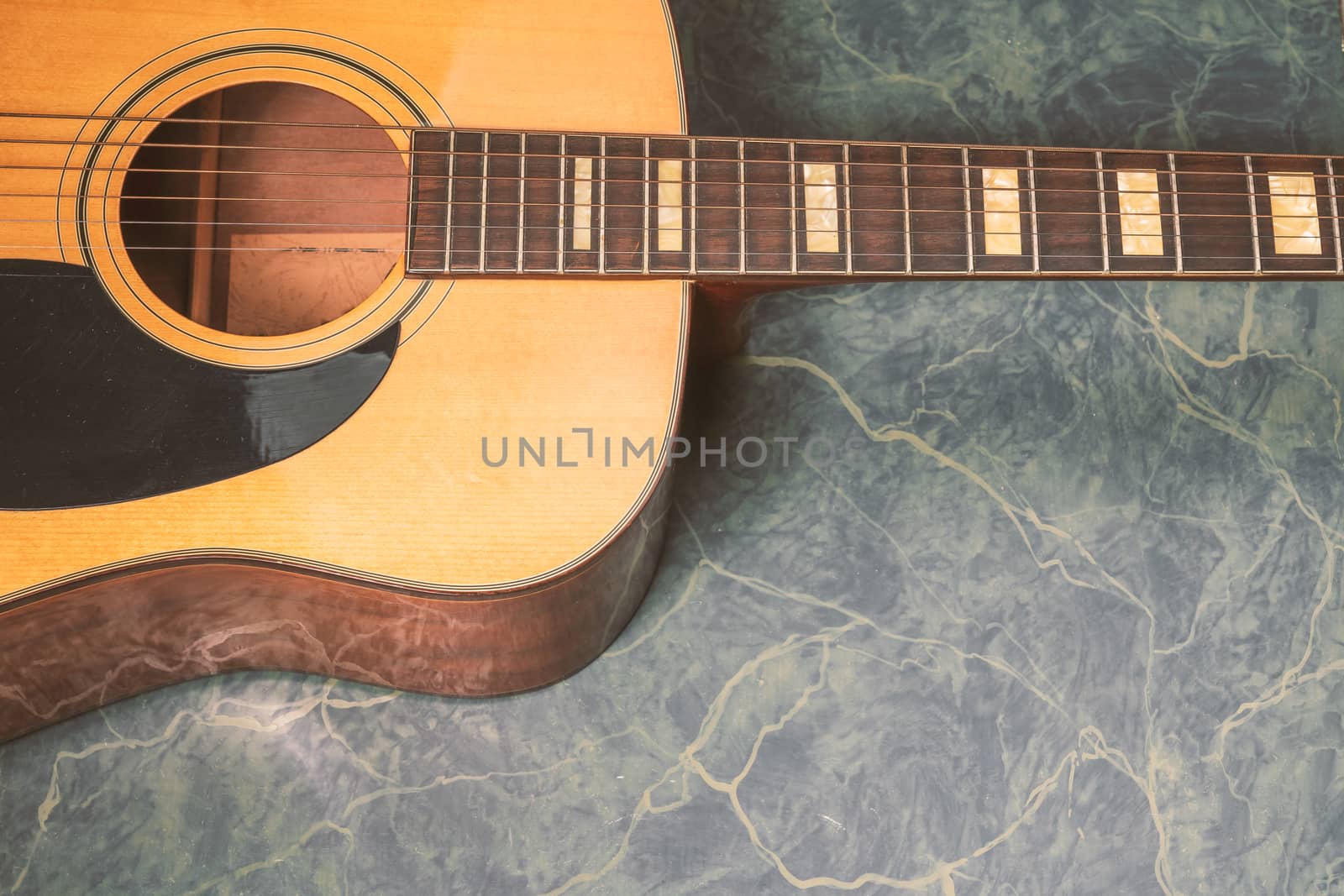 acoustic guitar details on  marble  background by Robertobinetti70