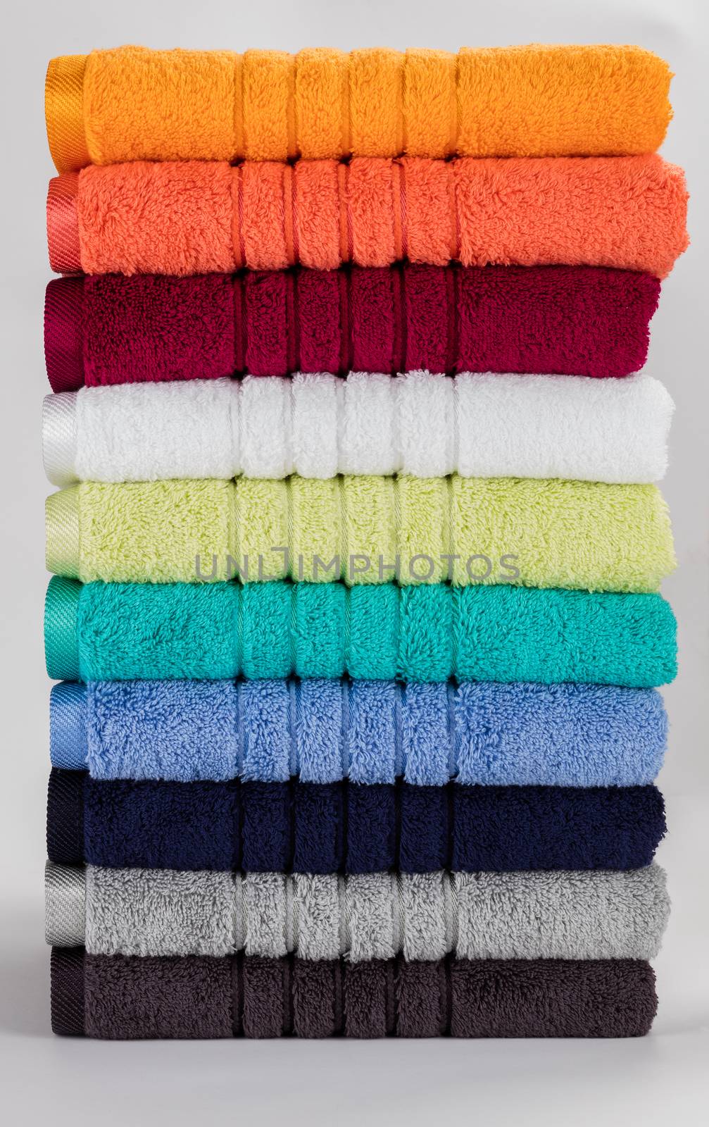 Multicolored towels on a white background by hanusst