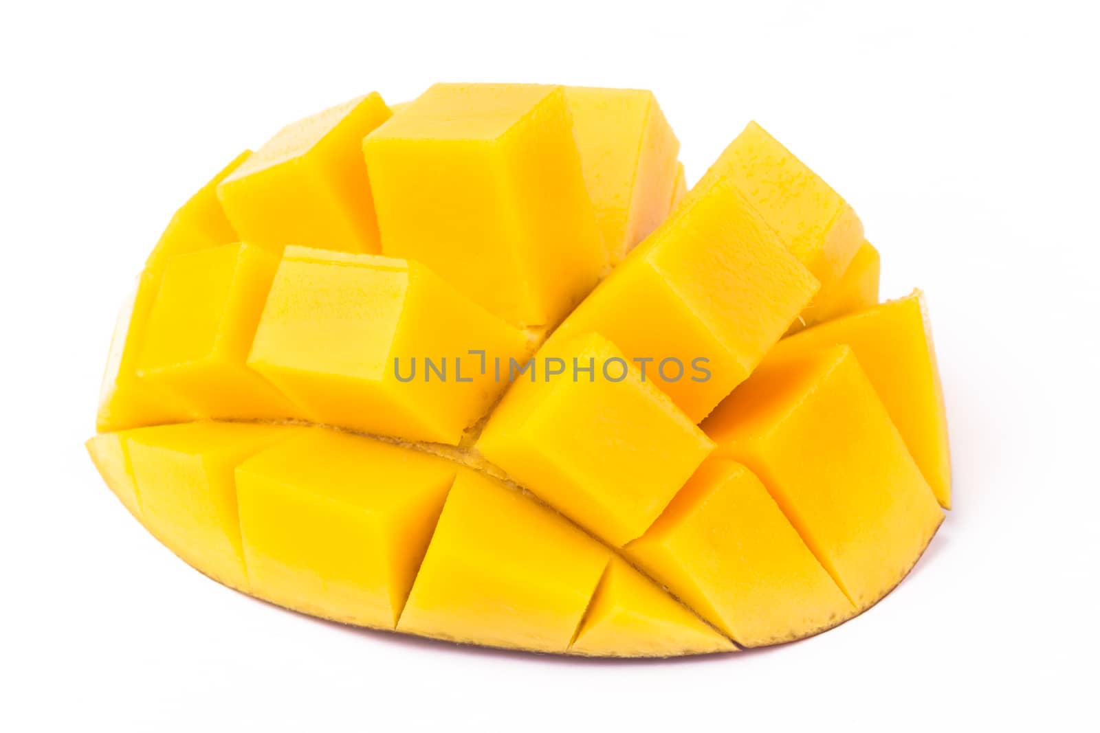Mango slice cut to cubes close-up isolated on white background