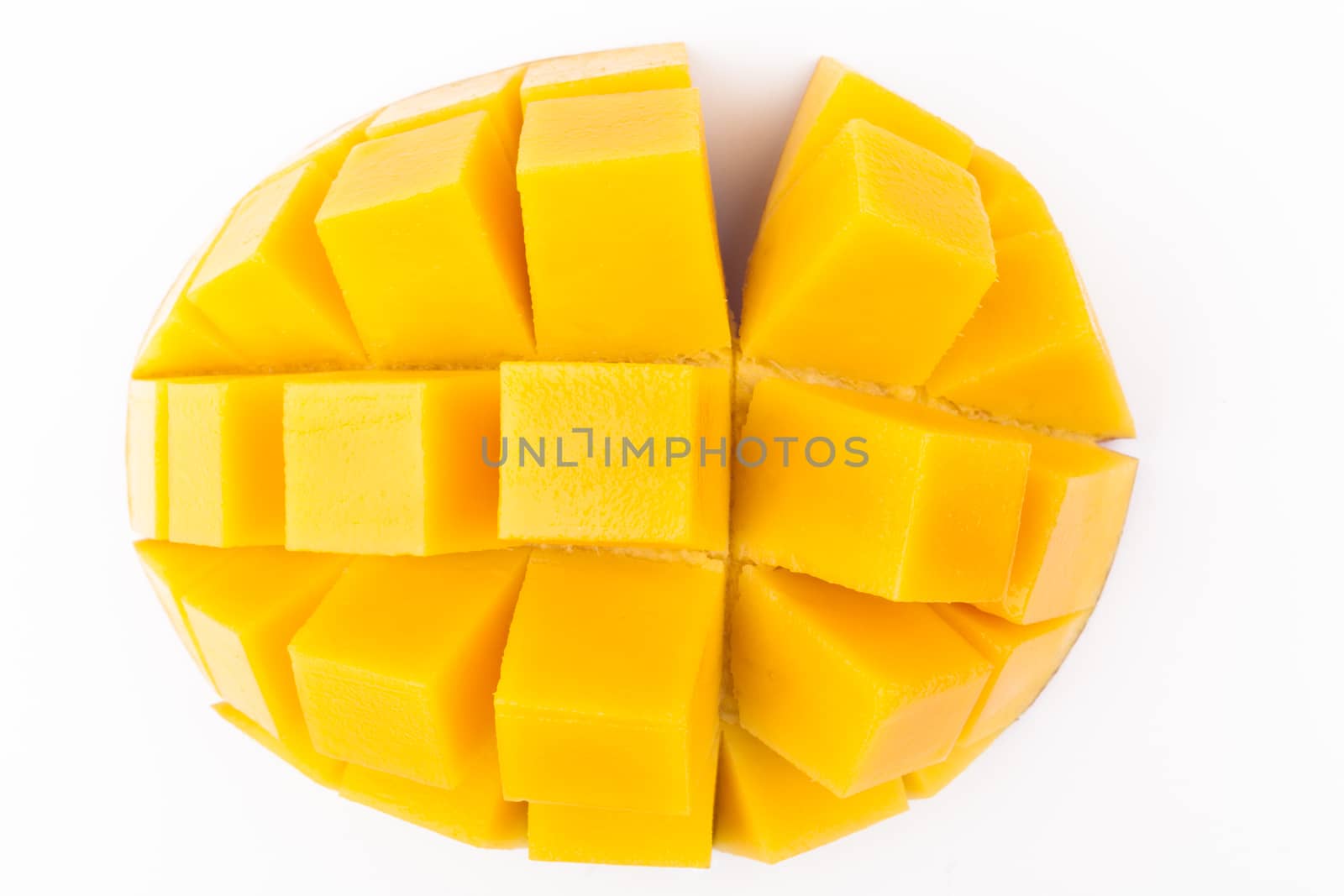 Mango slice cut to cubes close-up isolated on white background