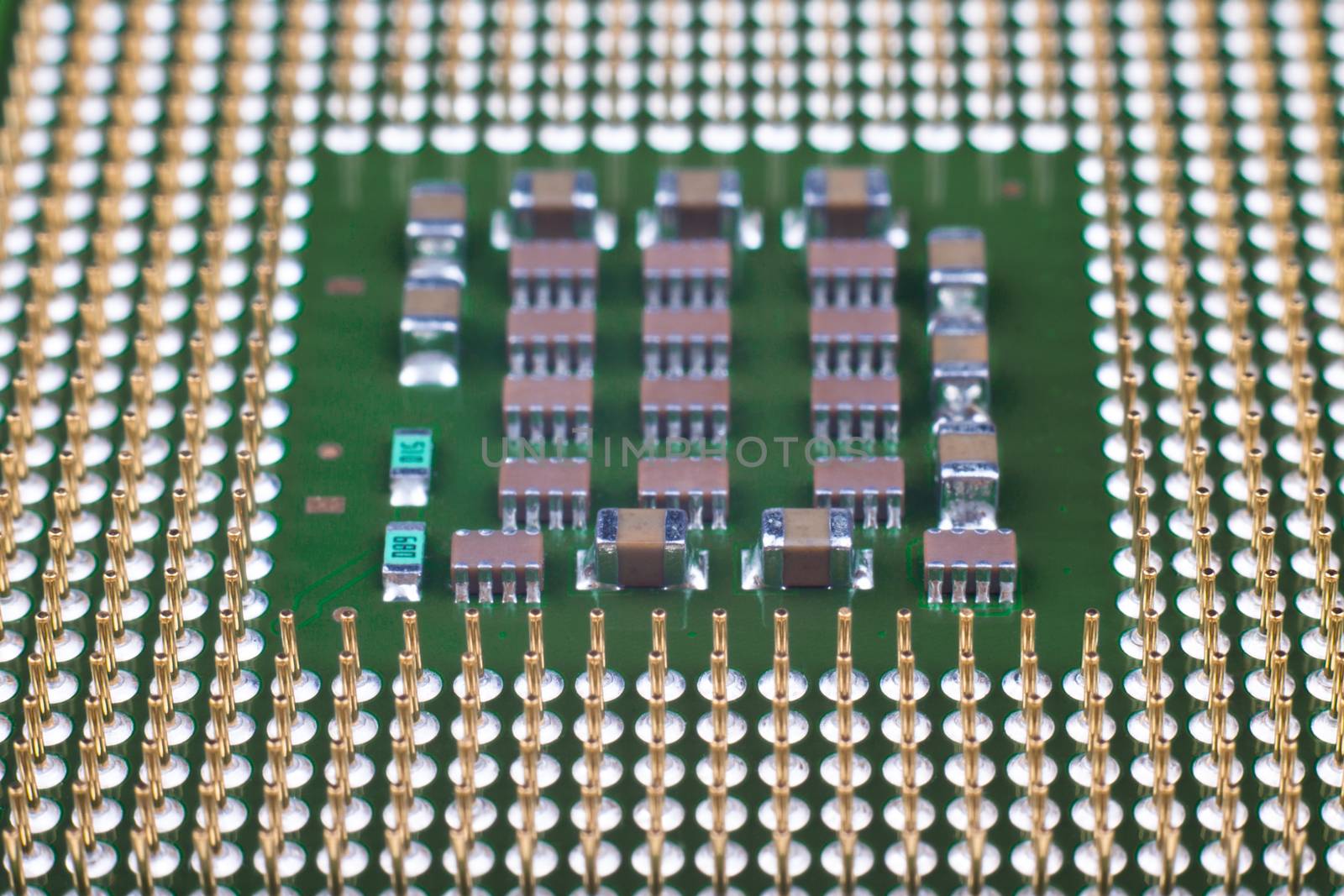 Microprocessor gold pins close-up with smd components
