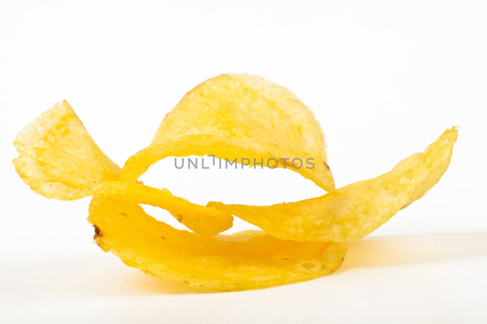 yelow potato chips pile isolated on white background